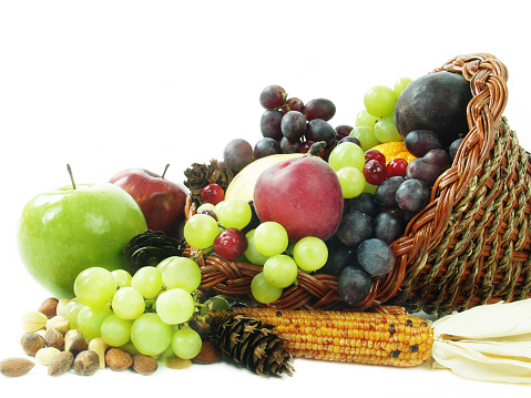 Apple and grapes in a basket isolated on white background. Wide photo. Free space for text.