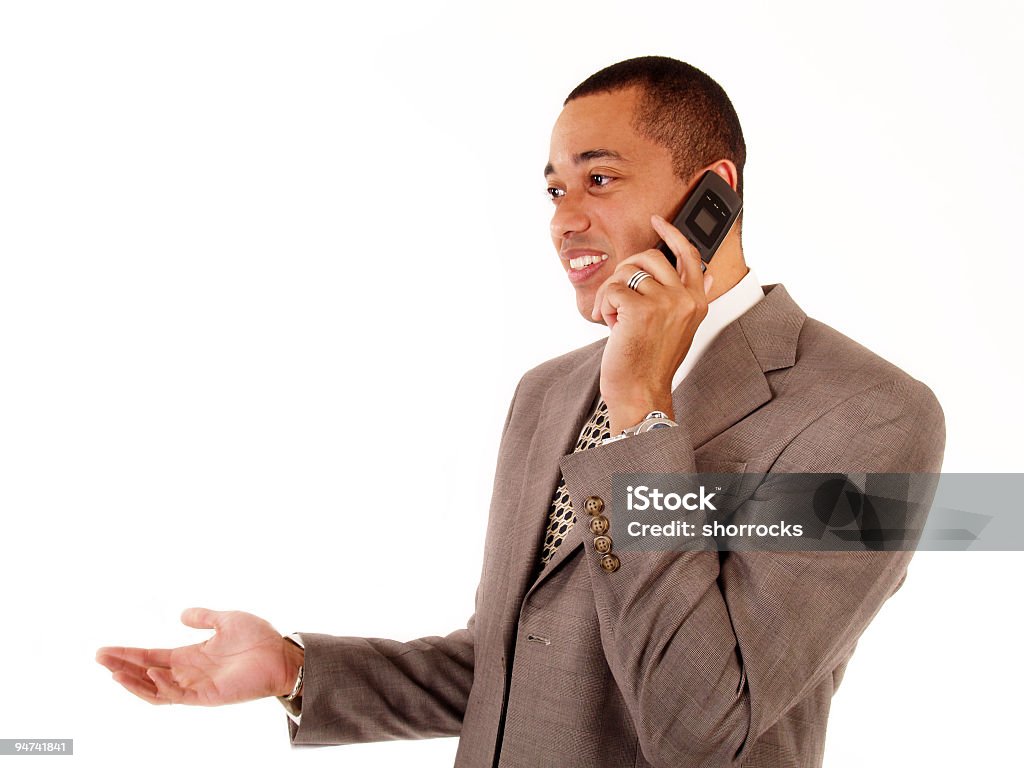 Cell Phone Conversation 1/2 length portrait of a business man talking on the cel phone; copy space  African Ethnicity Stock Photo