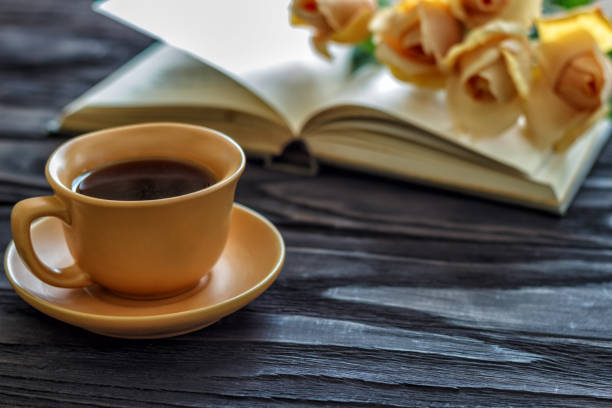 istock open book cup with coffee flowers roses on a wooden background with copy space, top view 947420676