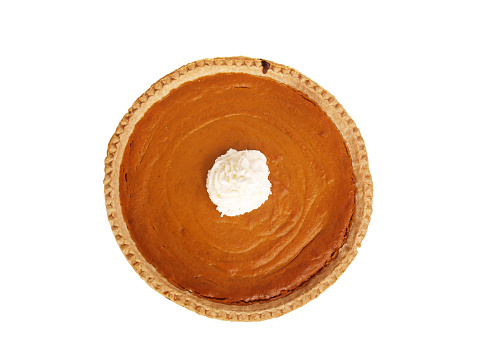 Whole pumpkin pie taken from directly above on a white background; whipped cream in center of pie; copy space 