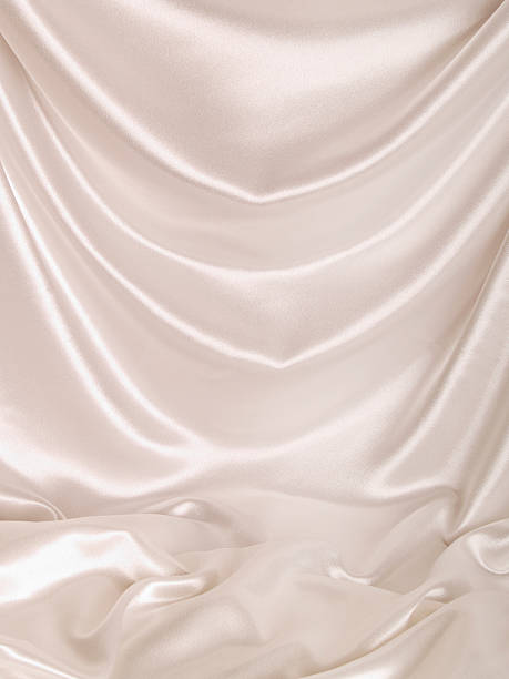 White Satin Backdrop Backdrop of silky, draped white satin with a soft pool of the fabric at the bottom of the frame; copy space  hanging fabric stock pictures, royalty-free photos & images
