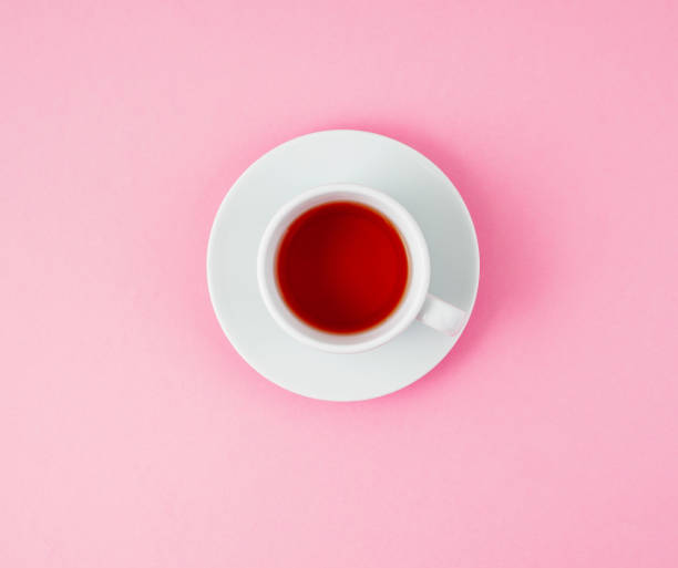 istock Cup of tea. Pink background, top view 947437702