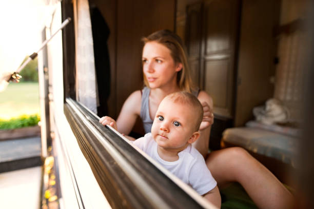 istock Mother and baby son in a camper van. 947438326