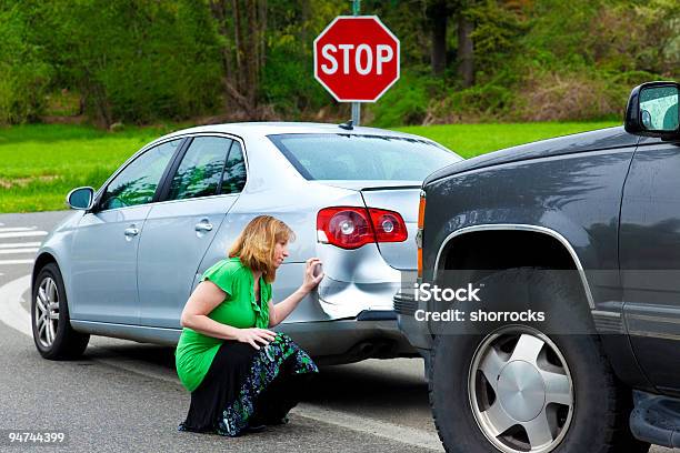 Woman Examining The Car Damage Stock Photo - Download Image Now - Dented, Accidents and Disasters, Adult