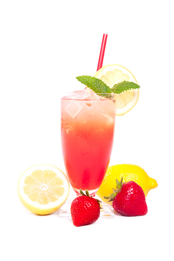 Full length photograph of a beautiful glass of strawberry lemonade with lemons and strawberries at foot of glass and mint to garnish; copy space 