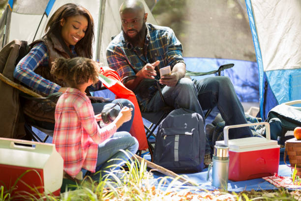 istock Family on summer or autumn vacation camping in forest. 947450792