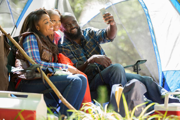istock Family on summer or autumn vacation camping in forest. 947450878
