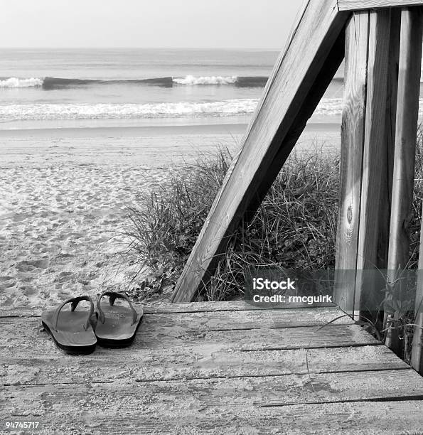 Leather Sandals On Boardwalk Steps At Beach Stock Photo - Download Image Now - Flip-Flop, Beach, Black And White