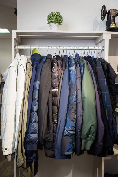 istock Clothes hang on a shelf in a designer store 947459192