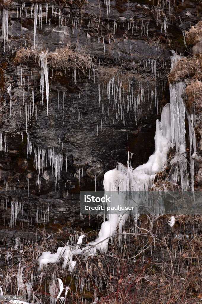 Dripping Icicles on Shale Wall Dripping icicles formed on a rough shale wall closeup abstract texture background. Beauty Stock Photo