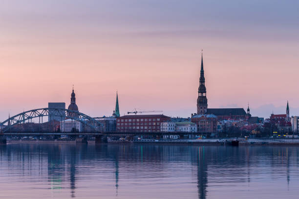 istock Night view on the illuminated riverside with reflection on the river in Riga 947466982