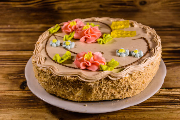istock Kiev cake with cream on wooden table 947471528