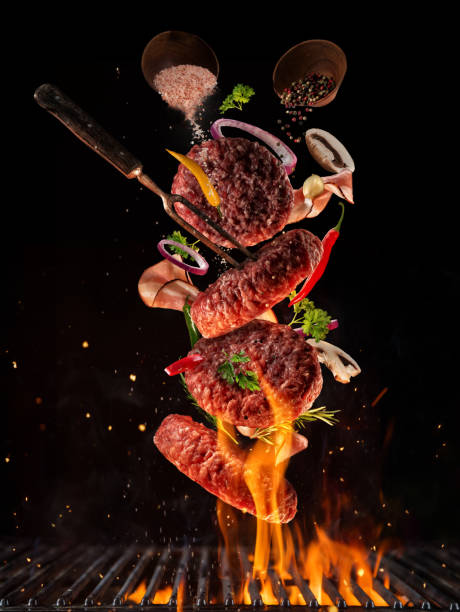 Flying pieces of beef meat pieces on hamburger from grill Flying pieces of beef meat pieces on hamburger from grill grid, isolated on black background. Concept of flying food, very high resolution image grilled photos stock pictures, royalty-free photos & images