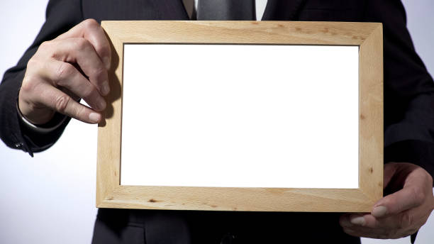 istock Businessman holding empty blackboard template for your text, advertising 947475130