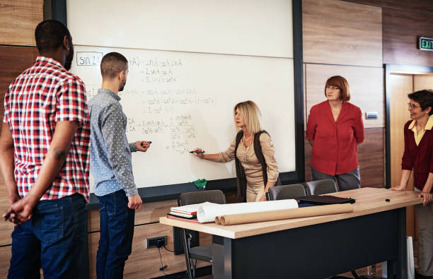 istock Adult students in lecture hall learning mathematics 947477594
