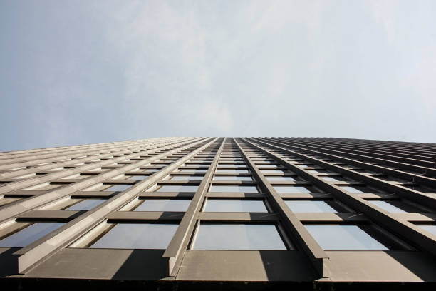 istock upward perspective of a tall skyscraper 947478142