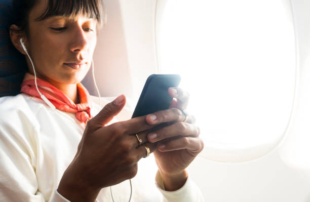 istock Woman posts to social media on airplane before take off 947478216