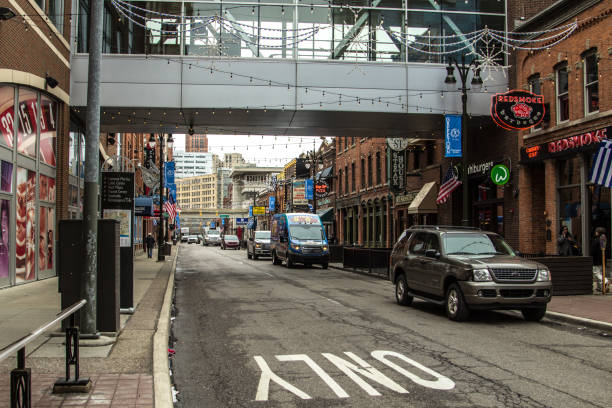 Downtown Detroit Michigan City Street With Traffic Detroit, Michigan, USA - March 20, 2018: Downtown Detroit Michigan city street scene in the vibrant Greektown neighborhood with traffic, local businesses and pedestrians. woodward stock pictures, royalty-free photos & images