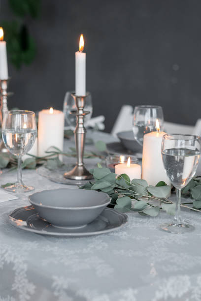 istock Wedding or festive table setting. Plates, wine glasses, candles and cutlery 947483458