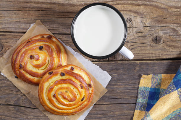 istock Sweet buns and mug of milk 947483658