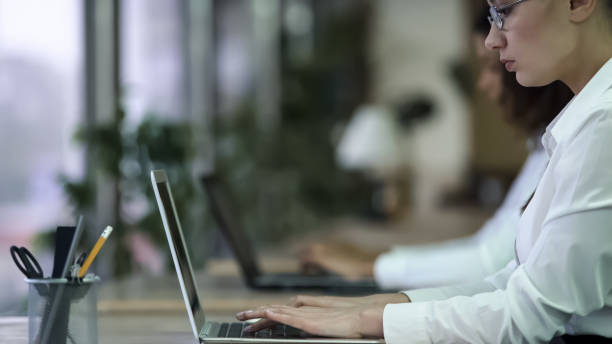 istock Focused female office employee working on urgent project, missing deadline 947483818