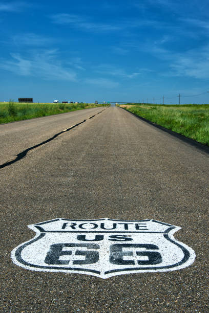 istock Historic Route 66 marker on asphalt with dark blue sky in background 947484434