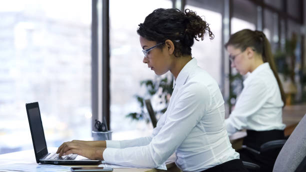 istock Pretty mixed-race lady typing on laptop, working for company support center 947484852