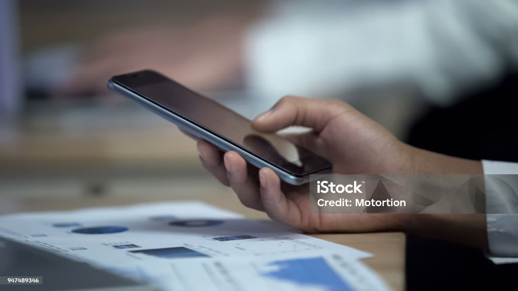 Worker Using Smartphone Office Worker Using Smartphone While Observing Charts Modern ...
