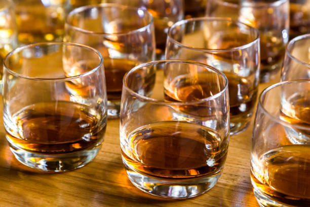 Glasses are filled with whiskey on the table