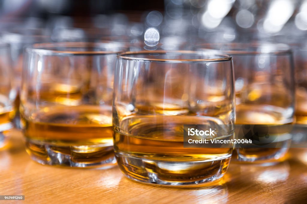 Glasses are filled with whiskey on the table Glasses are filled with whiskey on the table. Distillery Stock Photo