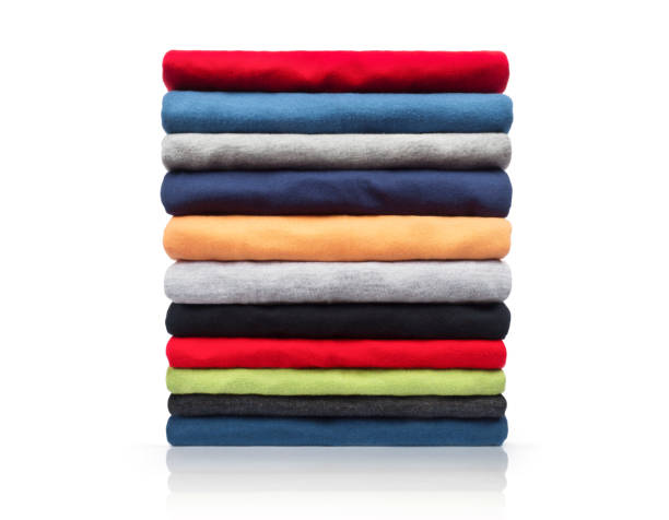 istock New colored clothing stacked in a pile close-up on white background 947496972