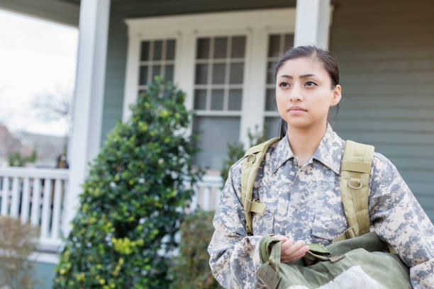 istock Serious female soldier leaving home 947502822