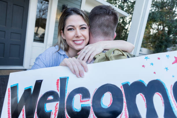 istock Woman welcomes husband home from military deployment 947502852