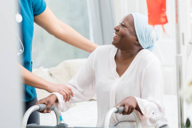 istock Unrecognizable nurse helps patient stand up 947503094