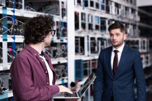 istock businessman and computer engineer working together at ethereum mining farm 947503702