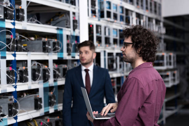 istock successful businessman and computer engineer working together at bitcoin mining farm 947507400