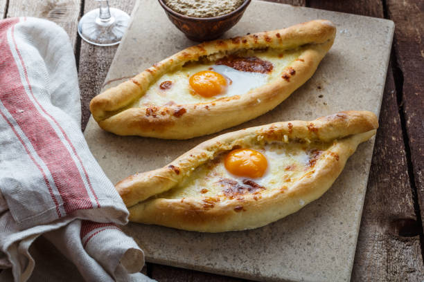 istock Two ajarian khachapuri, georgian bread with cheese and yolk 947515256
