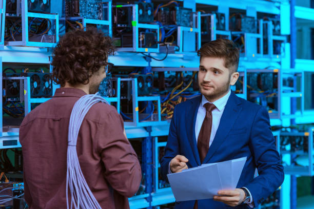 istock handsome businessman and computer engineer working together at cryptocurrency mining farm 947521780