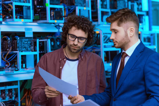 istock young businessman and computer engineer working together at ethereum mining farm 947522386