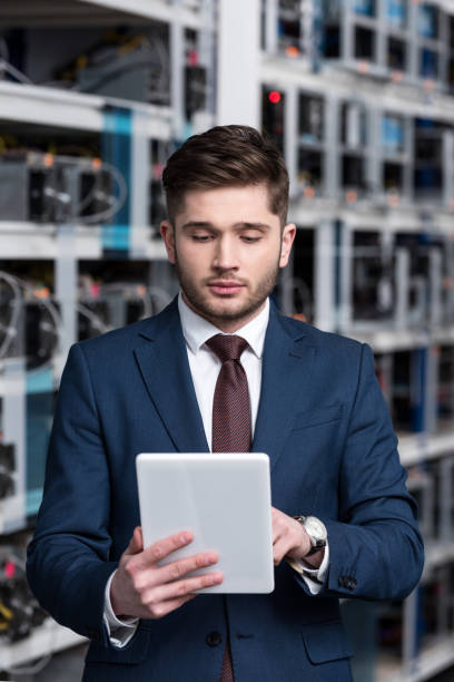 istock handsome young businessman using tablet at ethereum mining farm 947522754