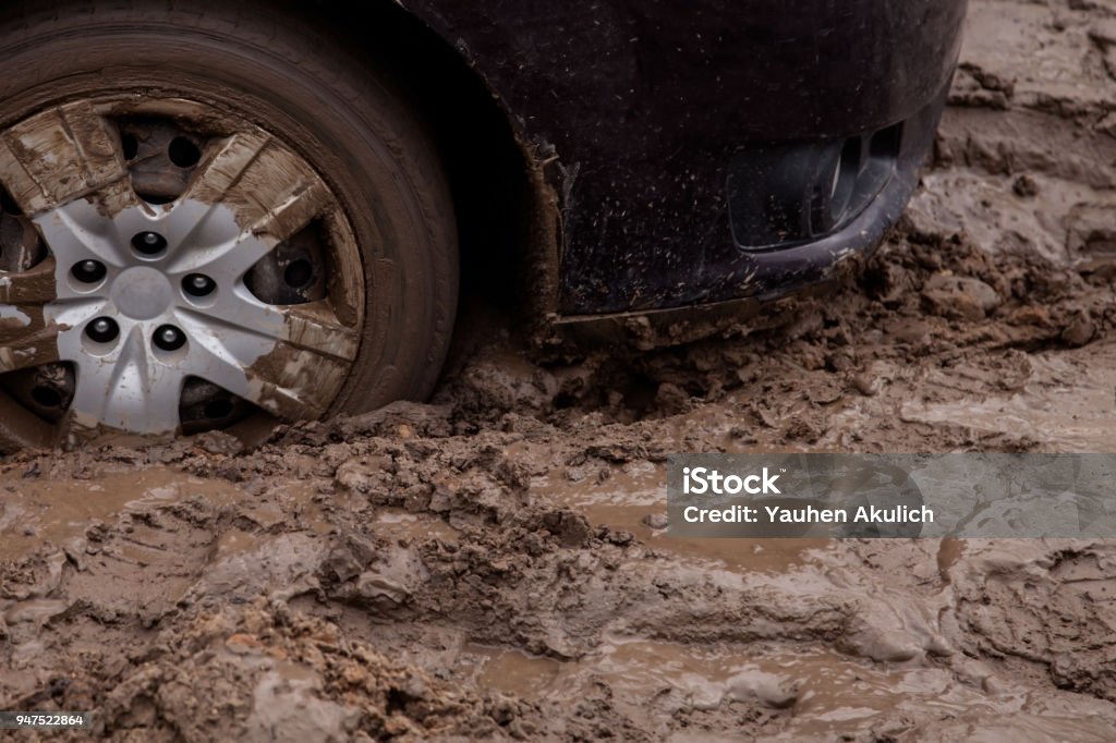 the car is stuck on a bad road in the mud the car got stuck in the mud Mud Stock Photo