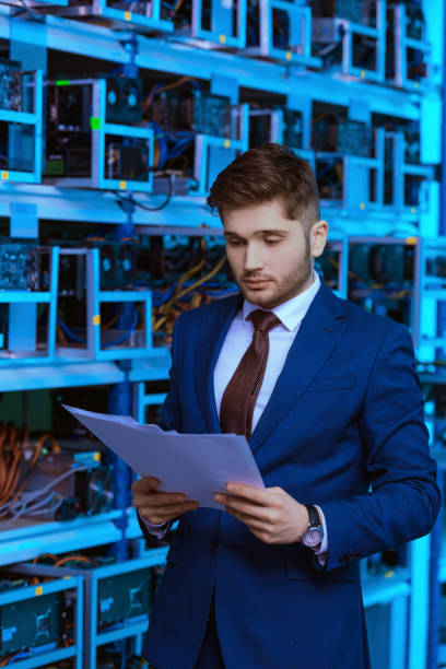 istock handsome young businessman reading documents at ethereum mining farm 947523274