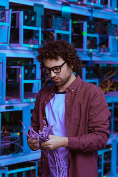 istock handsome computer engineer with ethernet wires at ethereum mining farm 947523550