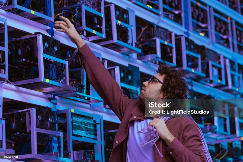 young computer engineer working at ethereum mining farm Ethereum Stock Photo