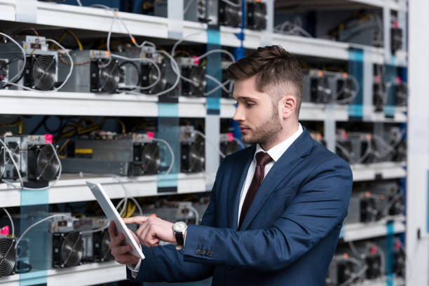 istock serious young businessman using tablet at ethereum mining farm 947526724