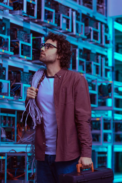 istock young computer engineer with wires on shoulder at ethereum mining farm 947526822