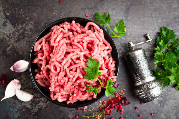 istock Raw ground beef meat with ingredients for cooking. Fresh minced meat 947536654
