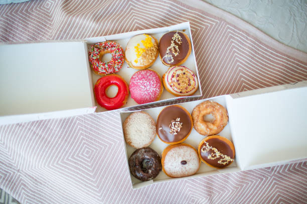 Colorful sweet donuts in box stock photo