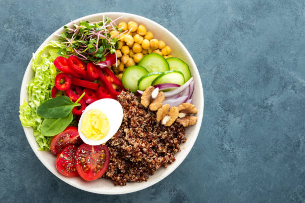 istock Buddha bowl dish with boiled egg, chickpea, fresh tomato, sweet pepper, cucumber, savoy cabbage, red onion, green sprouts, spinach leaves, chia and quinoa 947540548