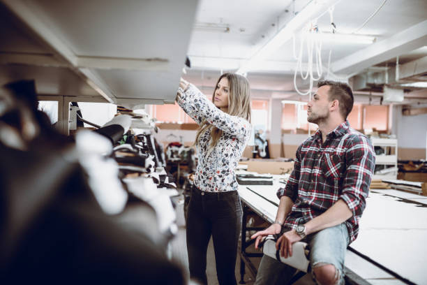 istock Young Fashion Designers Talking About Layout and Choosing the Material 947574084